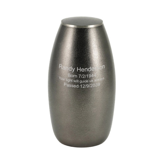 Close-up of the textured pewter and slate-finish brass cremation urn with wing design showing lid and surface finish