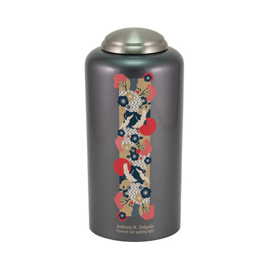 Dark gray-finish brass cremation urn with crane birds front view on white background