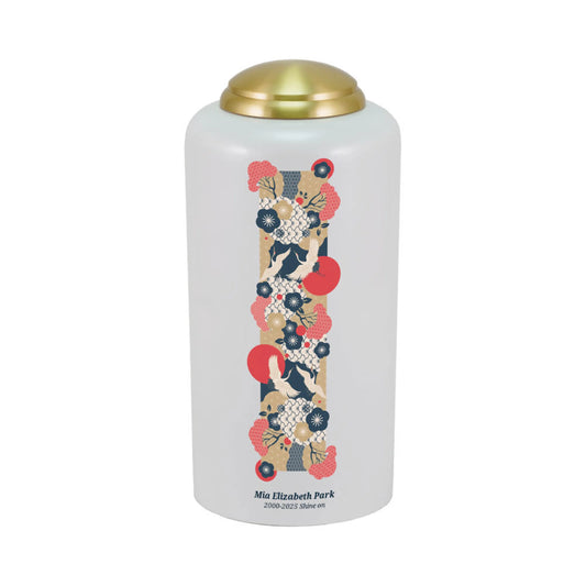 Pearlized brass cremation urn with crane birds front view on white background