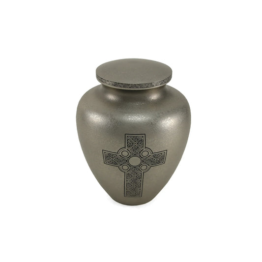 Brass cremation urn with design front view on white background