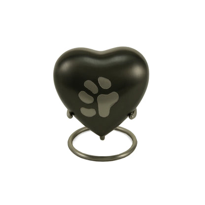 Brushed metal heart-shaped pet urn featuring an engraved paw print on a matching circular stand