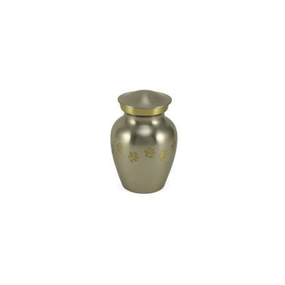 Metal pet urn in a brushed silver-grey finish featuring a gold trim band, rounded lid, and scattered gold paw prints