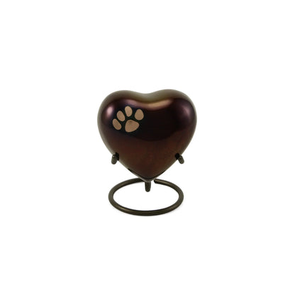 Metal heart-shaped pet urn featuring a glossy deep brown finish, a light gold paw print, and a dark metal ring stand