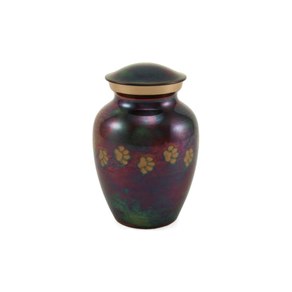 Metal pet urn featuring an iridescent deep purple and green finish with gold paw print details and a matching gold band beneath the domed lid