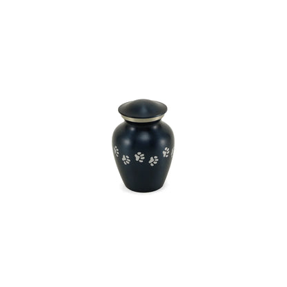 Metal pet urn with a dark blue finish, silver accent ring, and scattered white paw prints