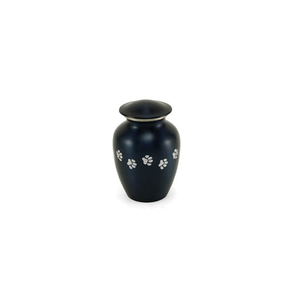 A dark blue pet cremation urn with a silver band on its lid and white paw print designs on a white background