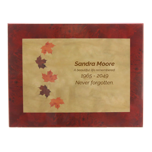 Wood-look MDF memorial box urn with leaf design front view on white background