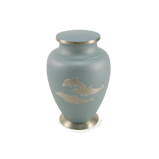 Brass cremation urn with dolphin design front view on white background