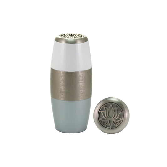 Pewter-finish brass tall cylindrical scattering urn with lotus motif upright on white background