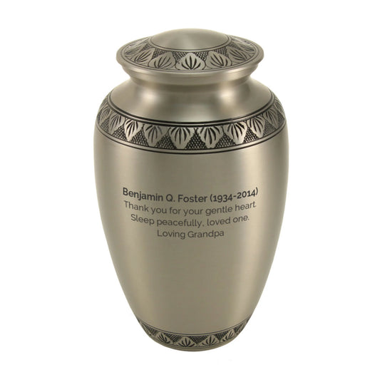 Pewter-finish brass cremation urn front view on white background, surface close-up