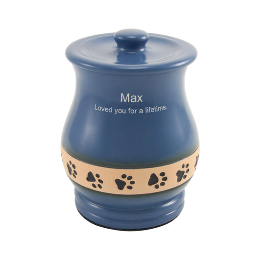 Blue ceramic cremation urn with paw print design front view on white background