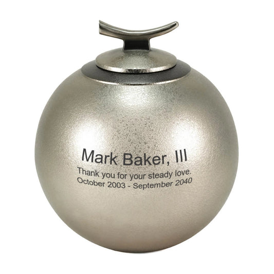 Close-up of the textured pewter-finish brass cremation urn showing lid and surface finish