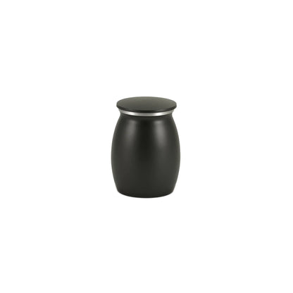 Small matte black barrel-shaped container with a flat lid featuring a silver metallic ring detail on a white background