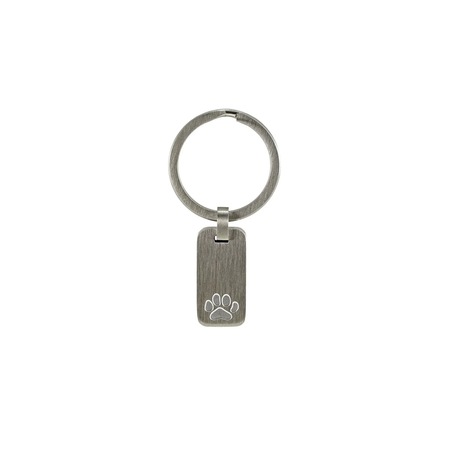 Brushed silver metal keychain with a rectangular tag featuring an engraved paw print attached to a round key ring