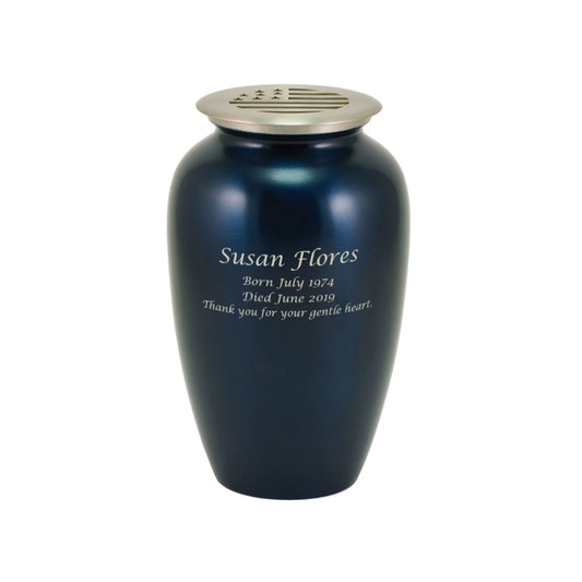 Midnight blue-finish brass tall cylindrical scattering urn with American flag motif upright on white background