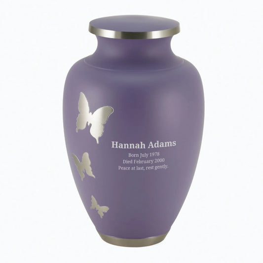 Brass cremation urn with butterfly design front view on white background