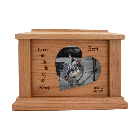 Cherry wood pet memorial box with paw accents around the photo opening and sample engraving