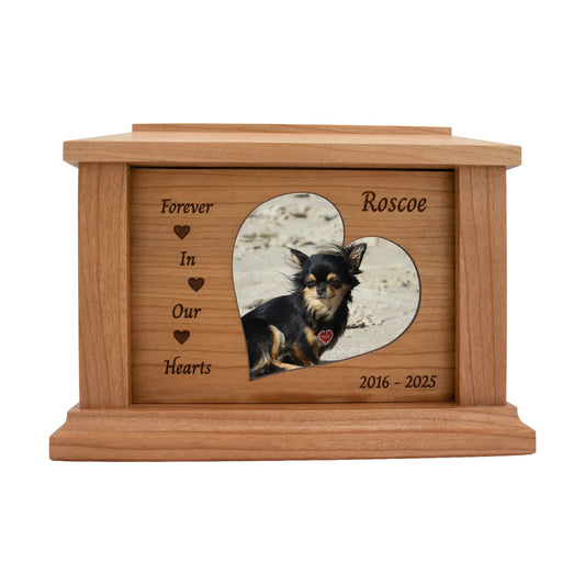 Cherry wood pet memorial box with heart accents around the photo opening and sample engraving, straight front view