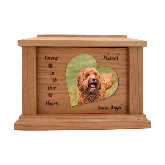 Cherry wood pet memorial box with paw accents around the photo opening and sample engraving, straight front view