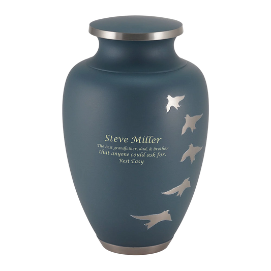 Brass cremation urn with ascending bird silhouettes front view on white background