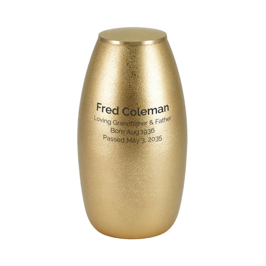 Close-up of the textured bronze and pewter-finish brass cremation urn with wing design showing lid and surface finish