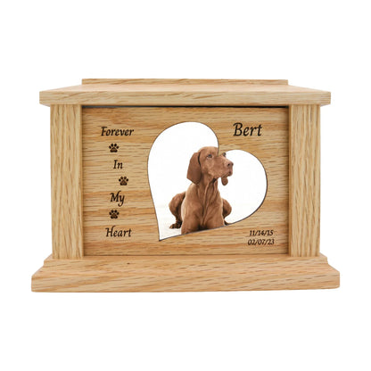 Light oak pet memorial urn with a heart-shaped photo cutout featuring a brown Vizsla dog, engraved "Forever In My Heart" with paw print accents, the name "Bert", and dates 11/14/15 02/07/23