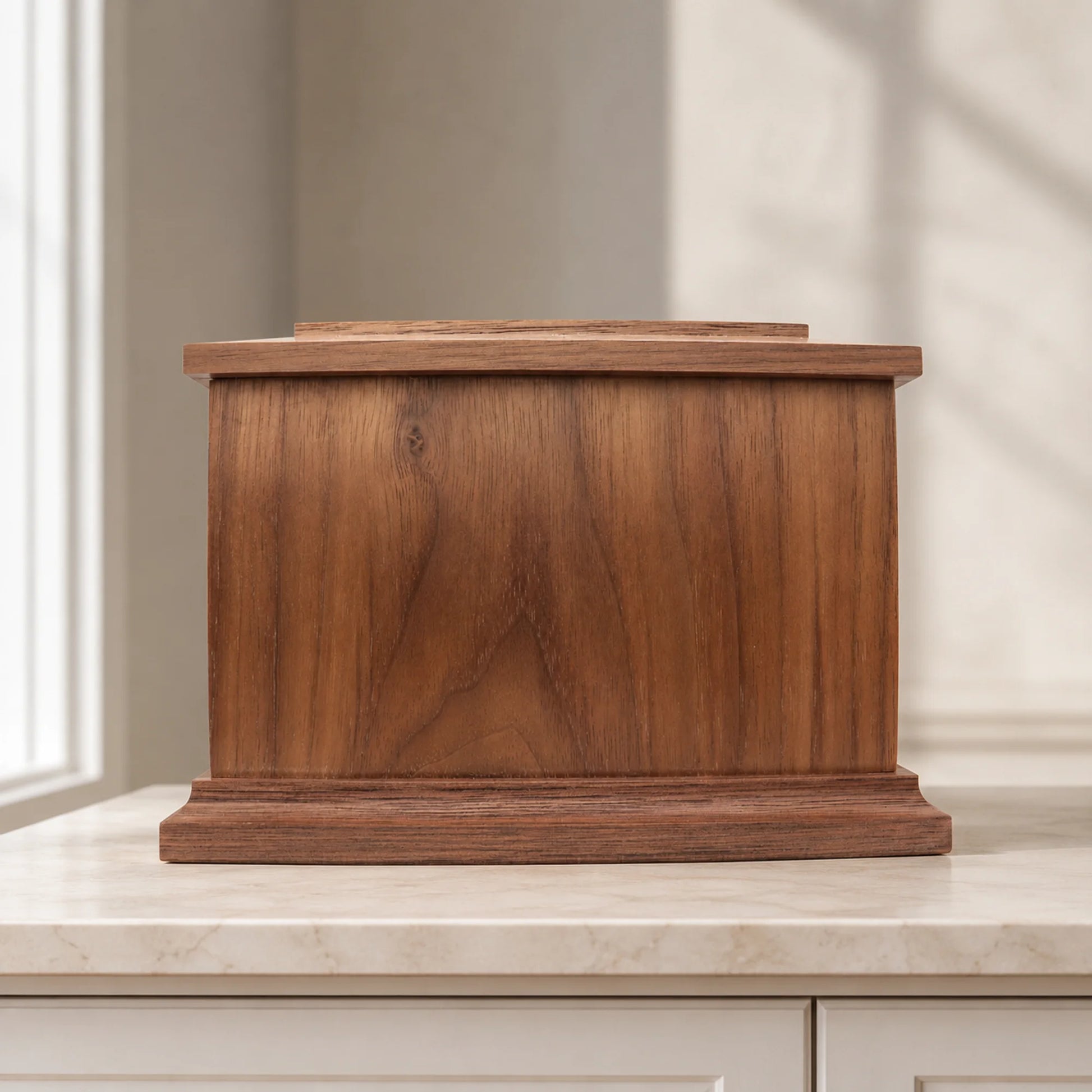 Rear view of walnut wood memorial box with screw-secured removable storage panel