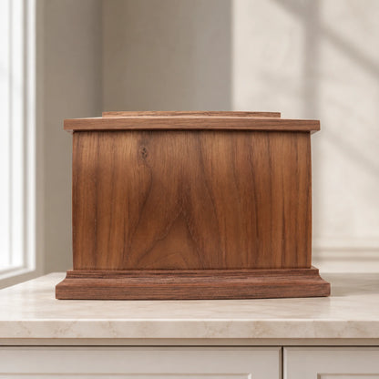 Rear view of walnut wood memorial box with screw-secured removable storage panel
